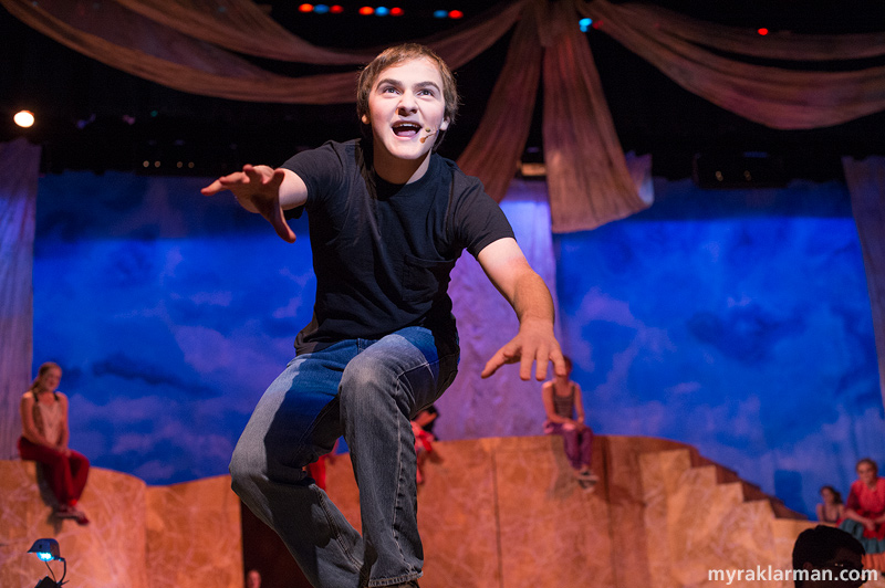 Pioneer Theatre Guild: Pippin | Pippin (Oren Steiner) gets up close and personal with the audience, singing “Corner of the Sky” on a sturdy extension of the Schreiber stage, great job sets!