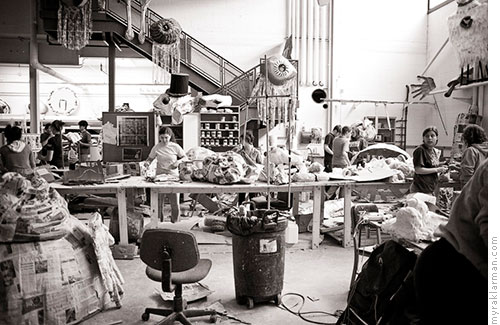 Marching towards FestiFools 2008 | U-M students and community volunteers work side-by-side in the FestiFools studio. Puppets from last year’s parade oversee the progress from the rafters.