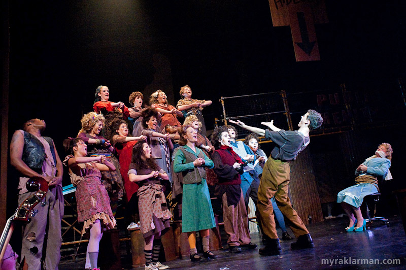 Pioneer Theatre Guild: Urinetown | Bobby Strong (Robby Eisentrout) leads a paupers’ choir in one of my favorite numbers, Run Freedom Run. 