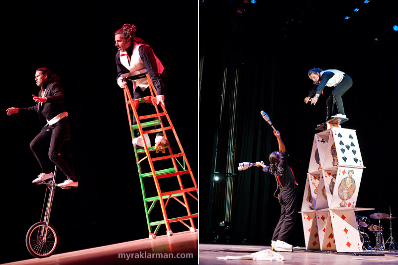 Ann Arbor Summer Festival 2009 | Circo Comedia at the Power Center. My vantage point is perhaps not the best to fully appreciate what this duo did. One of them is wearing roller skates (more specifically, one inline skate and one “traditional” roller skate). The ladder is rickety (at best) — although to call it “rickety” is to pay it a rather undeserved compliment. In point of fact, it was busting apart at critical junctures, which made it completely — utterly and hilariously — unsound. In the photo on the right, the dude’s balanced atop a board that’s rolling freely atop a cylinder that’s rolling freely atop a (literal) house of cards. And several of the consituent cards had just been — accidentally, I’m sure — knocked over. Trust me, it’s a miracle these guys aren’t in traction.