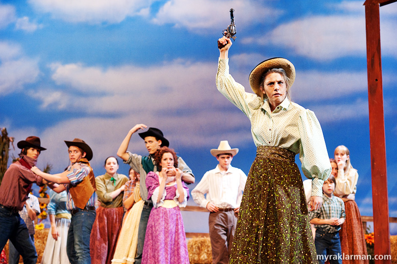 Pioneer Theatre Guild: Oklahoma! | Aunt Eller (Emily Steward) imposes peace between the cowboys and the farmers.